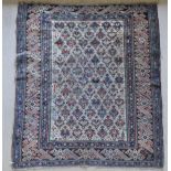 A Caucasian rug, the central panel set with repeating design on a cream ground,