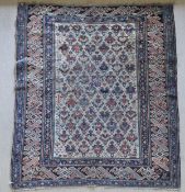 A Caucasian rug, the central panel set with repeating design on a cream ground,