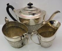 A late Victorian silver three piece tea set comprising teapot, twin-handled sucrier and milk jug,