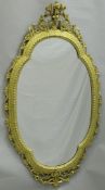 A 19th Century shaped wall mirror with giltwood frrame and scroling rococo style top,