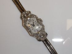 A 1920's white gold and diamond set cocktail watch with Arabic numerals and later strap,