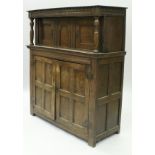 An 18th Century oak court cupboard with applied moulded cornice and arched central panel flanked by