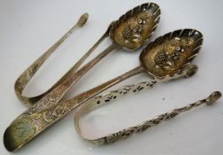 A pair of Georgian silver serving spoons with later embossed and engraved berry and floral
