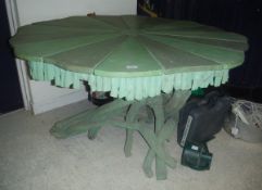A green painted shaped segmented top centre table with a driftwood base