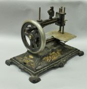 A late 19th Century German cast iron sewing machine with gold transfer decorated floral motifs,