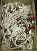A box of various costume jewellery to include pearl necklaces and other bead necklaces