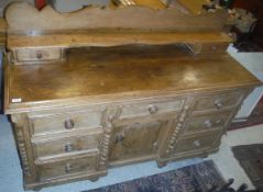 A Victorian pine dresser with galleried back to plain top above two banks of three drawers flanking
