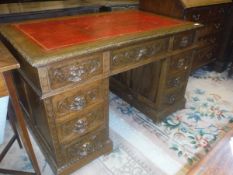 A Victorian carved oak double pedestal desk in the Gothic Revival taste,