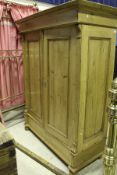 A pine double wardrobe and a pine glazed two door kitchen cupboard