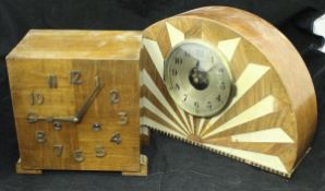 A 1930's Art Deco dome top mantle clock with simulated ivory inlaid starburst decoration,