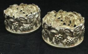 A pair of modern silver grape and vine decorated coasters (London 1990),