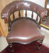 A Victorian Captain's chair with buttoned upholstered back rail above turned spindles,