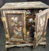 A late 19th Century Japanese black lacquered and mother of pearl decorated table-top cabinet,