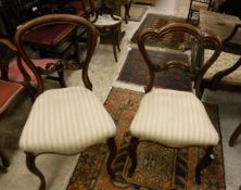 A set of three Victorian rosewood framed dining chairs and a set of three Victorian mahogany framed