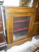 A Victorian walnut and marquetry inlaid side cabinet with single glazed door on a bracket foot base