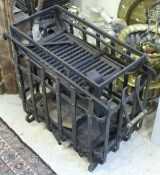 A large wrought iron log basket and a further cast iron fire basket with pair of dogs