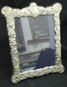 A modern embossed Carrs silver photograph frame in the Victorian taste CONDITION REPORTS
