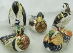 A collection of five Royal Crown Derby Japan pattern bird figures including "Penguin and Chick LXI"