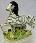 A Victorian Staffordshire flatback figure of a zebra