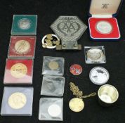 A box containing various commemorative coinage, medallions,
