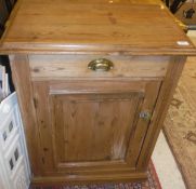 A Victorian pitch pine cupboard with drawer over a fielded panel door