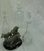 Four various glass decanters and stoppers and a Juliana Collection figure of "Three Running Wolves"