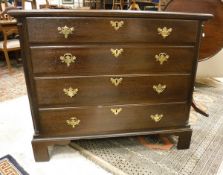 An oak chest in the George III manner of four long graduated drawers flanked by fluted quarter cut