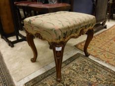 A Victorian walnut framed needlework dressing stool on cabriol legs to scroll feet