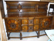 An early 20th Century oak sideboard with two central drawers flanked by cupboard doors,