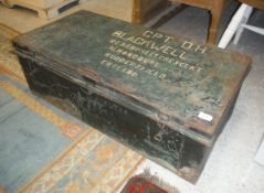 A painted tin trunk inscribed "CPT. D.