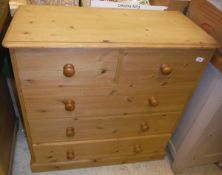 A modern pine chest of two short over three long drawers on a plinth base