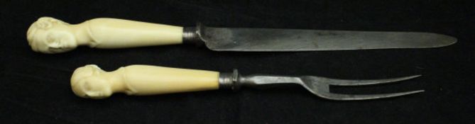 A pair of ivory handled carving knife and fork,
