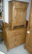 A 19th Century Continental pine cabinet with rising top over a dummy drawer and single cupboard