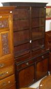 A mahogany bookcase in the Chippendale taste with two glazed doors enclosing four shelves on a base