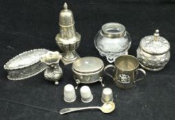 A collection of small silver wares to include silver pepper, baluster match striker,