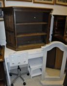 An oak bookcase of three shelves flanked by linen-fold moulded panelled doors,