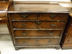 An 18th Century walnut chest of two short over three long graduated drawers to bracket feet