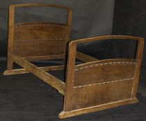 An early 20th Century oak double bedstead by Ernest Gimson with headboard and footboard,