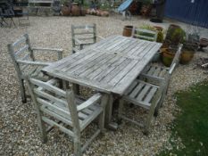 A teak slatted garden table and six chairs (four plus two) CONDITION REPORTS All