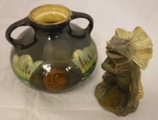 An Austrian painted pottery figure of a seated frog in a cape in the manner of Goldscheider,