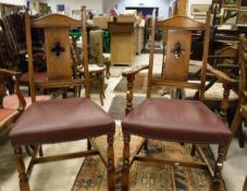 A set of eight early to mid 20th Century oak framed dining chairs (6 plus 2 carvers)