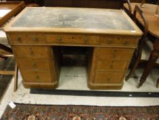 A late Victorian oak pedestal desk with three drawers,