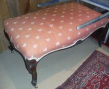 A Victorian rosewood framed drawing room stool, the upholstered seat above a shaped frieze,