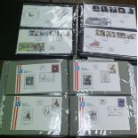 A box containing eight folders and a box of first day covers