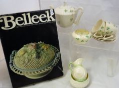 A Belleek part tea set comprising teapot, two cups,