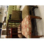 A green button back headboard and four assorted chairs,