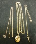 A 9 carat gold crucifix on a microchain, together with a 9 carat gold locket on a chain,