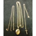 A 9 carat gold crucifix on a microchain, together with a 9 carat gold locket on a chain,