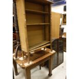 A 20th Century oak extending dining table, a leaded glazed oak arched top shelving unit,