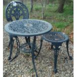 A painted cast metal garden table and matching chair and similar backless chair